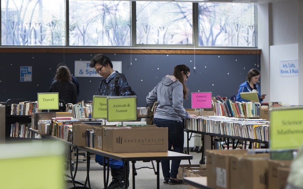 A few people browse the tables full of free books at the Friends of the Library book sale Monday morning. The Friends of the Library bookstore normally sells books at a discounted price on the ground floor of the Monroe County Public Library, but today all of their books were free with no limit on how many someone could take. 
