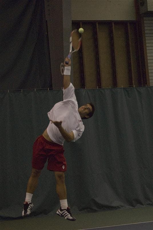 Sophomore Santiago Gruter serves during a doubles match against Western Kentucky Saturday afternoon at IU Tennis Center. The Hoosiers started their season off with a 3-0 victory on Saturday against Western Kentucky, Toledo and Gardner-Webb University.