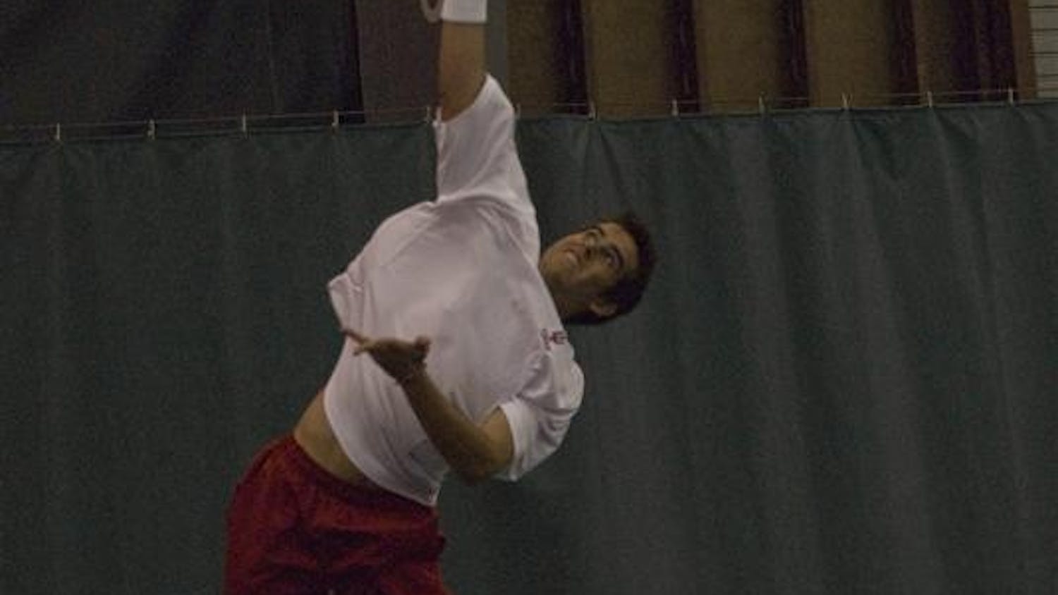 Sophomore Santiago Gruter serves during a doubles match against Western Kentucky Saturday afternoon at IU Tennis Center. The Hoosiers started their season off with a 3-0 victory on Saturday against Western Kentucky, Toledo and Gardner-Webb University.