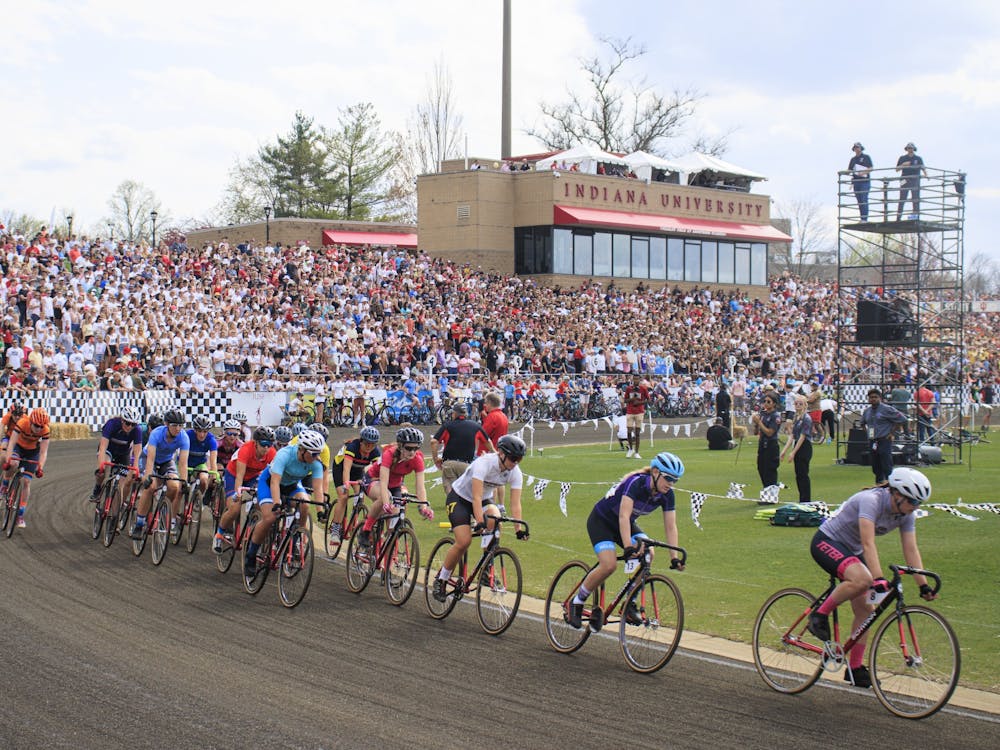 Riders compete in front of a full crowd on April 22, 2022, at Bill Armstrong stadium. Fans made signs to hold up during the race wore shirts with their team&#x27;s colors.