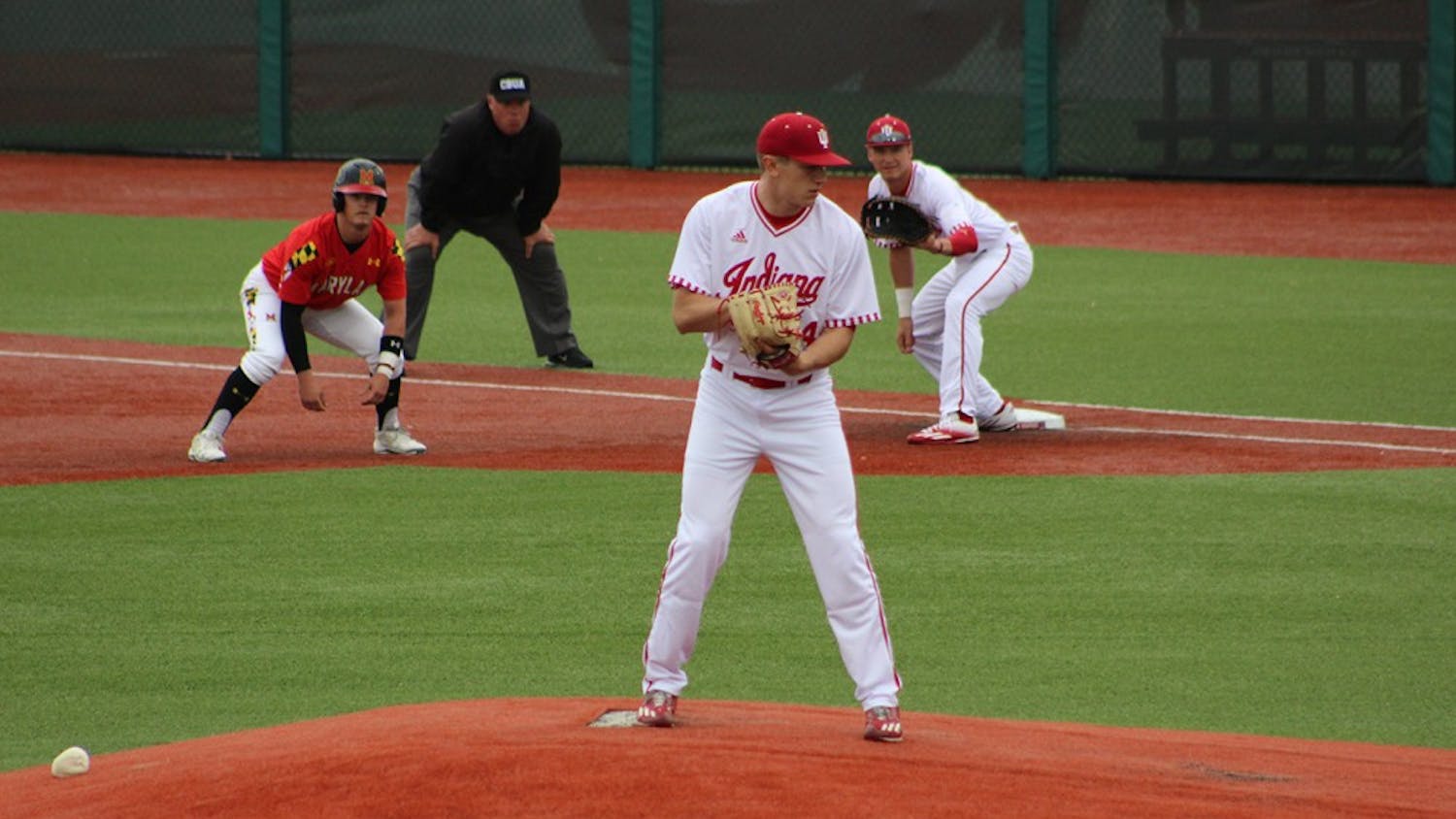 Sophomore starter Jonathan Stiever tries to hold on a baserunner in his start Friday vs. the Maryland Terrapins. The runner was later picked off before the lightning delay.