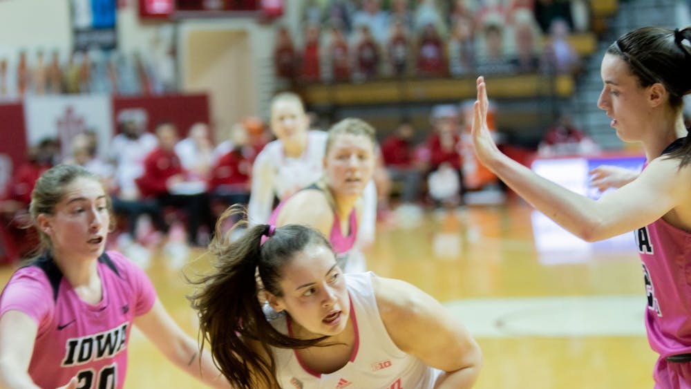 Sophomore forward Mackenzie Holmes secures the ball against the Iowa defense Wednesday at Simon Skjodt Assembly Hall. The Hoosiers were down 38-43 to the Hawkeyes at halftime.
