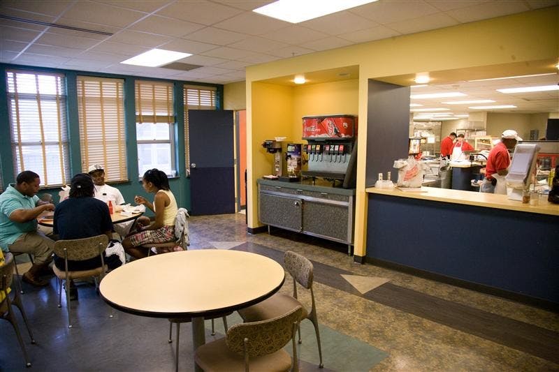 Students sit down to eat together inside the Eigenmann Eatery.