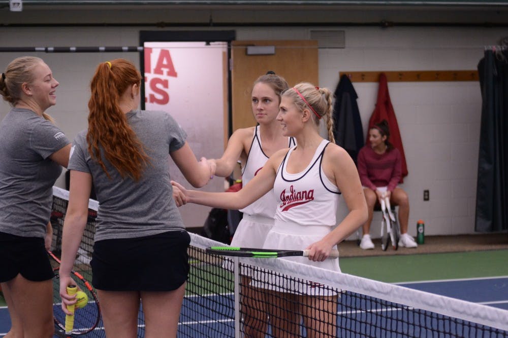 Sophomores Emma Love and Pauline Jahren shake hands with their opponents after their win of 7-5 at the IU Winter Invitational Tournament. The Hoosiers get set to play Western Michigan and Butler this Saturday to begin dual match play.