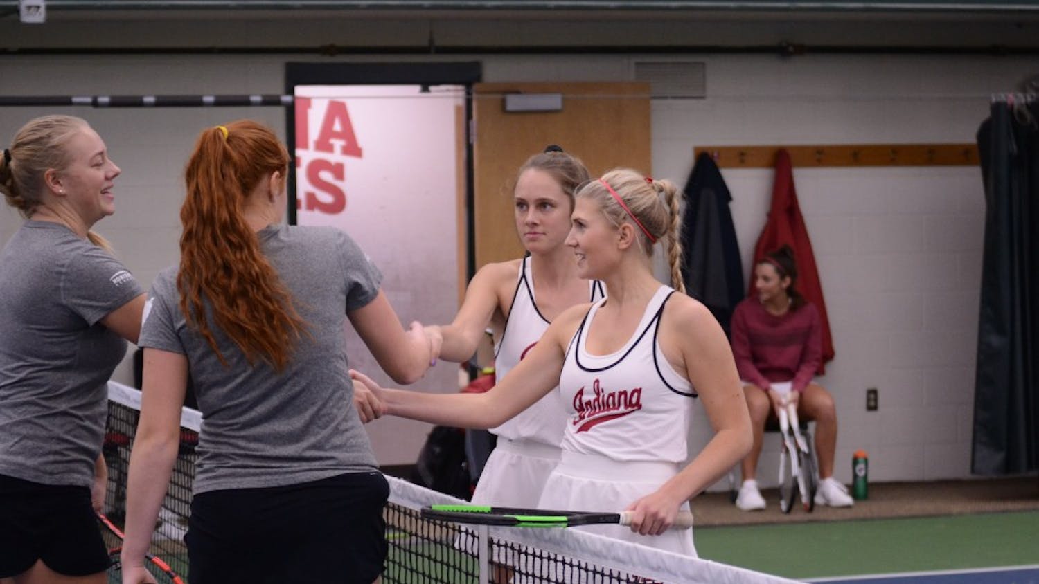 Sophomores Emma Love and Pauline Jahren shake hands with their opponents after their win of 7-5 at the IU Winter Invitational Tournament. The Hoosiers get set to play Western Michigan and Butler this Saturday to begin dual match play.