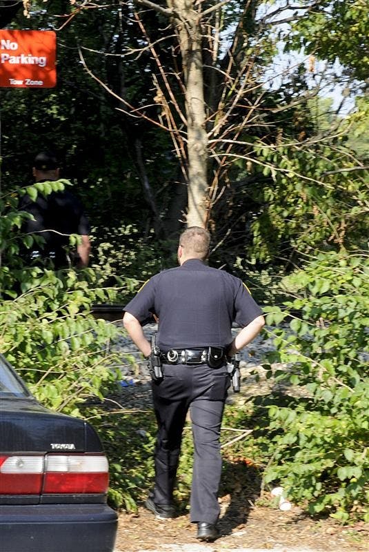 Indiana University Police Department officers investigate the scene of a train death on Wednesday afternoon near Eigenmann Quad.
