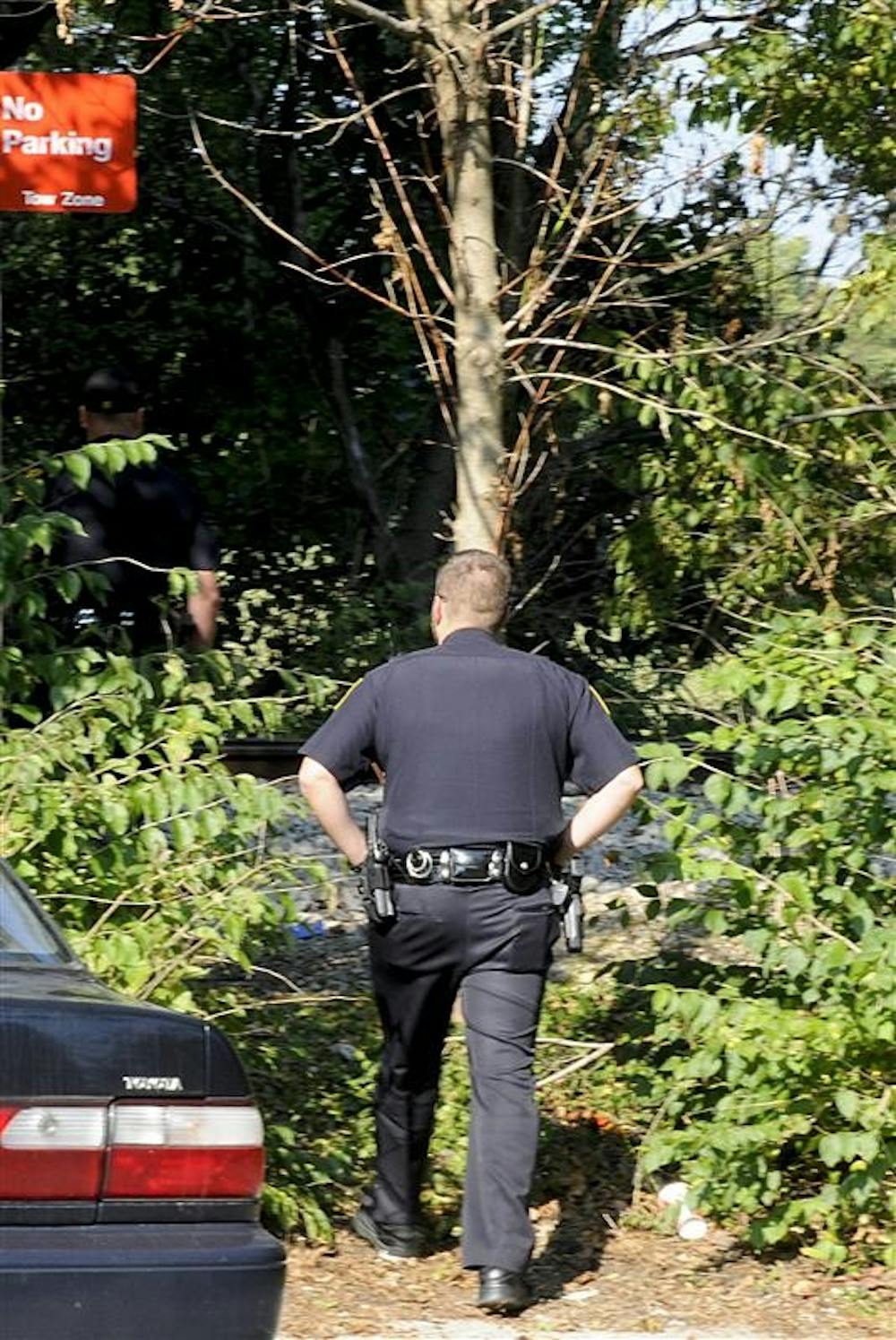 Indiana University Police Department officers investigate the scene of a train death on Wednesday afternoon near Eigenmann Quad.