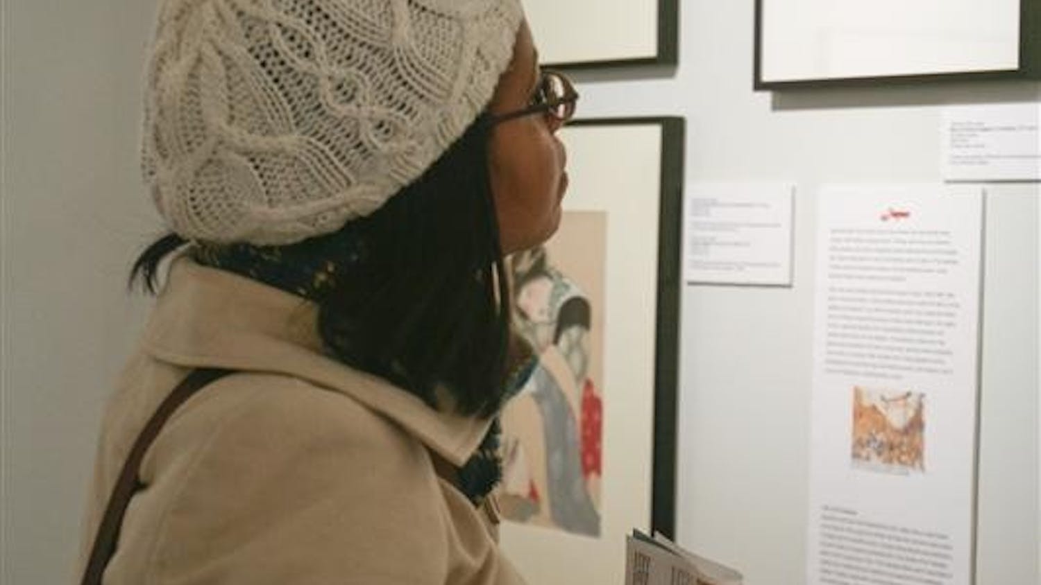 Graduate student Nikole Miller looks at pieces of featured artwork Friday evening at the Kinsey Institute's exhibit "Eros in Asia: Erotic Art from Iran to Japan." The exhibit will be on display until June 26.
