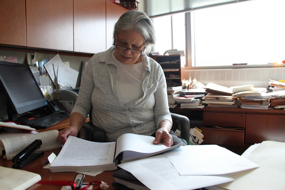 Fran Watson, an IU law professor, looks over the original police report on the "bump, rape and rob." The victim told police she was assaulted by young, black men. Darryl Pinkins was 38 at the time.