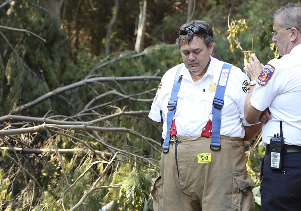 Van Buren Township Fire Department Deputy Chief Ed Terrell (left) and Ellettsville Fire Department Chief Mike Cornman investigate the scene of a plane crash near Monroe County Airport on Thursday afternoon.