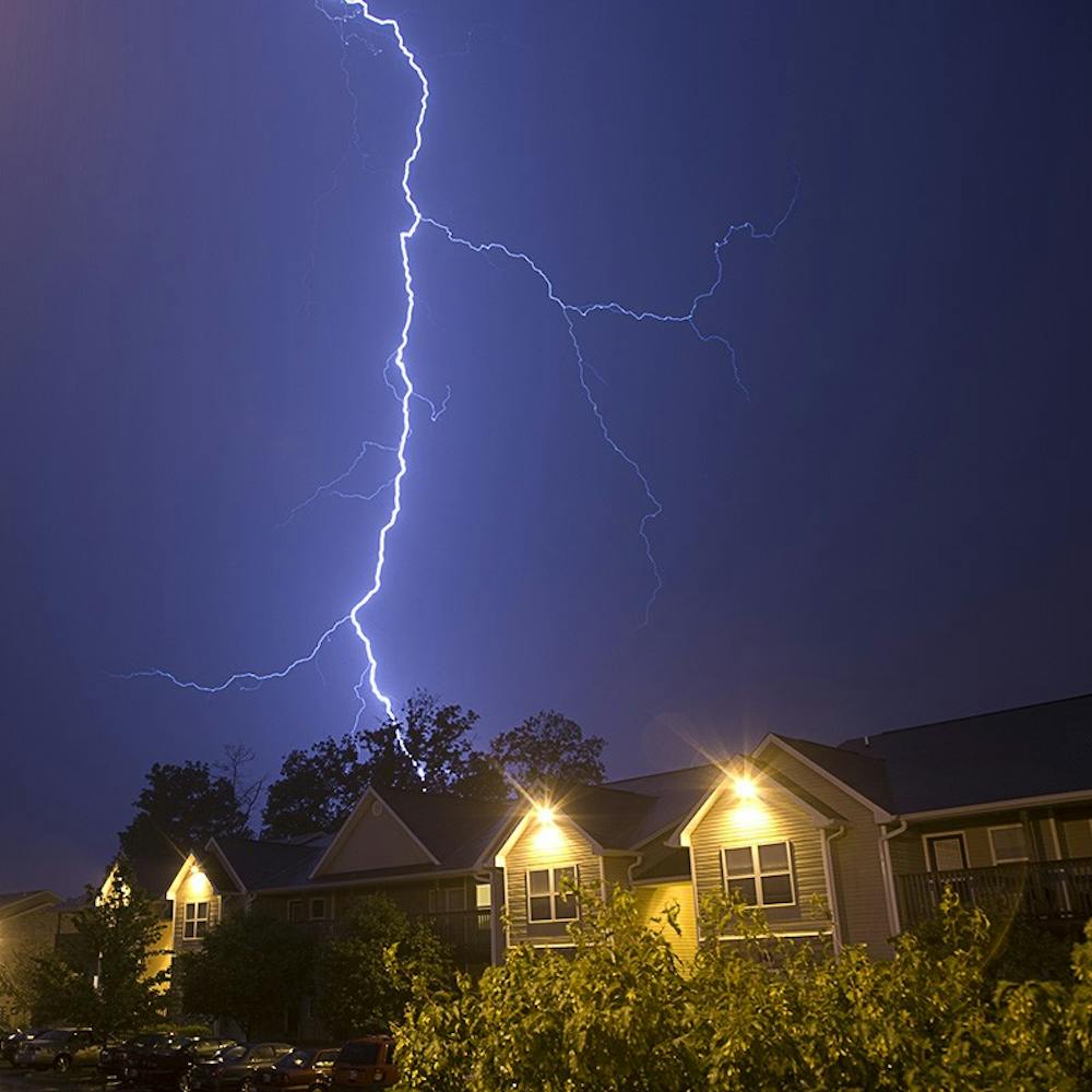 Brandon Foltz / IDS
Lightning strikes during severe weather Friday night over Bloom Apartments on South Adams Street. Several more storms passed through the area Friday night adding to rainfall that caused Wednesday's flooding.