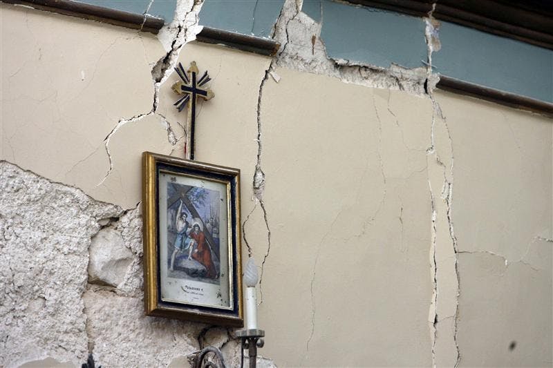 Cracks are seen in the wall of a house Monday in the village of Castelnuovo, central Italy, following a strong earthquake. A powerful earthquake in mountainous central Italy knocked down whole blocks of buildings early Monday as residents slept, killing more than 90 people in the country's deadliest quake in nearly three decades, officials said. Tens of thousands were homeless and 1,500 were injured.