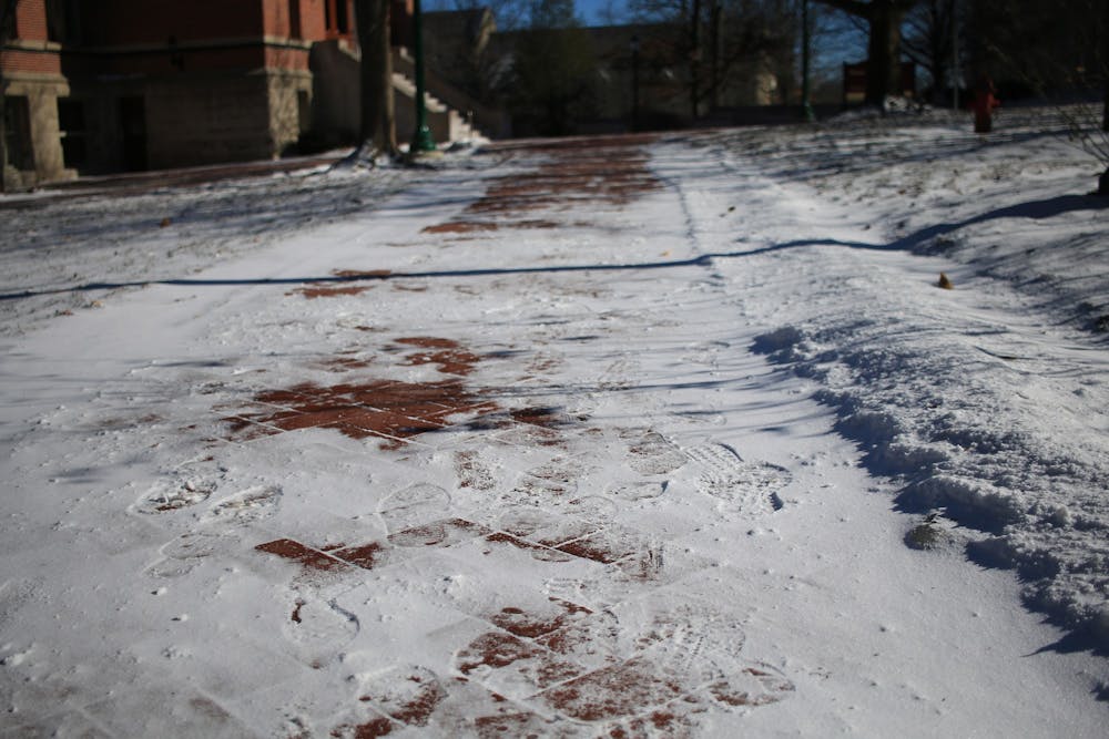 <p>Footprints are seen on the snow-covered paths Jan. 30, 2019, through IU’s empty campus. Bloomington is expected to receive 8 to 12 inches of snow Thursday.</p>