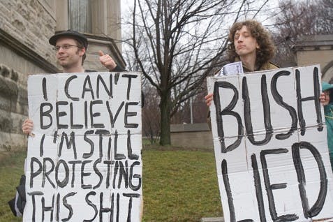 IU seniors Aeoban Binder and Andrew Webber protest the Iraq war Wednesday with the ISAW. President Bush recently spoke about the war in Iraq as the fifth anniversary passed.