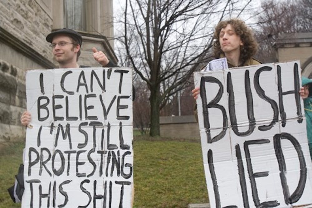 IU seniors Aeoban Binder and Andrew Webber protest the Iraq war Wednesday with the ISAW. President Bush recently spoke about the war in Iraq as the fifth anniversary passed.