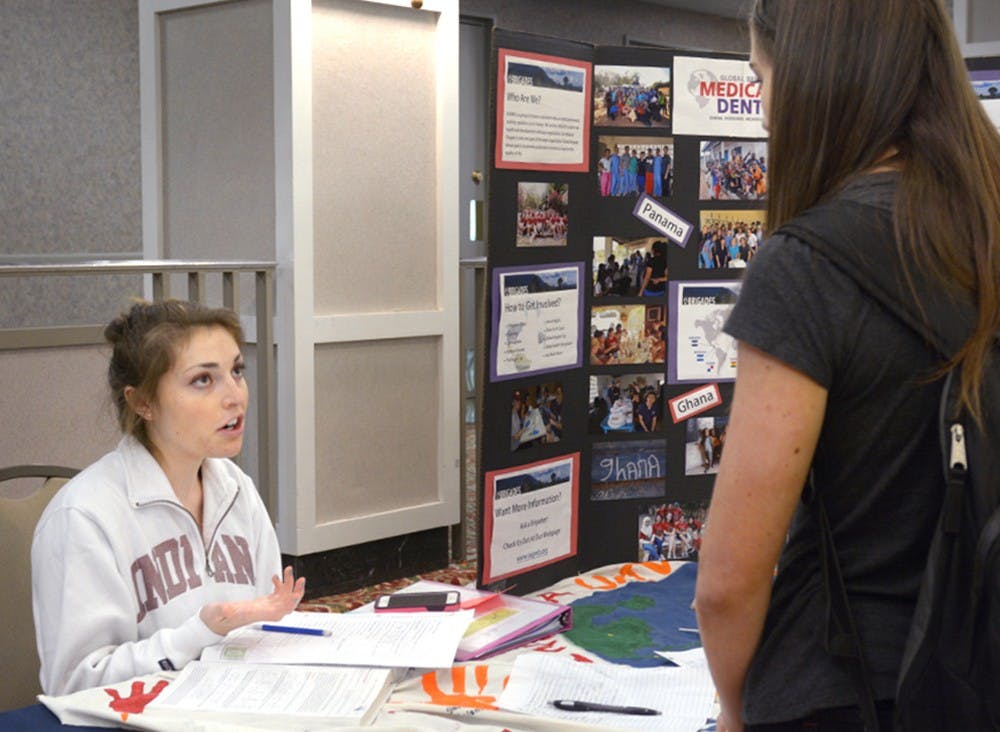 IU junior Alie Magnante talks to a student about the travel opportunities Global Medical Brigades at IU have during spring and winter breaks at the Alternative Break Fair at the IMU on Wednesday afternoon. The trips are aimed to help set up health clinic and provide medical care for developing countries.