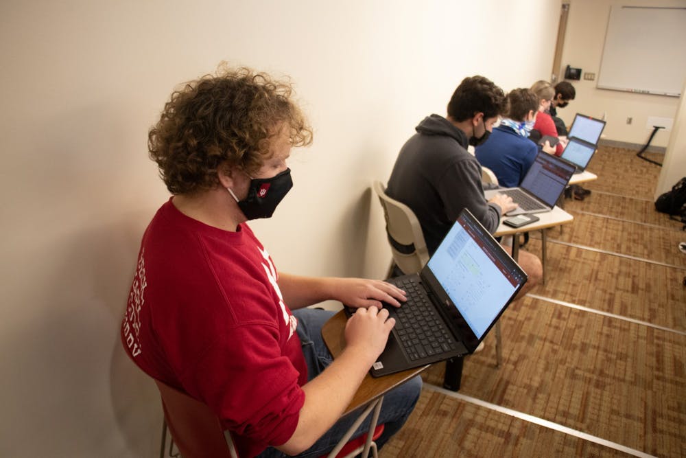 <p>Junior Corbin Dubois looks at his computer during a class on Oct. 21, 2021, in Franklin Hall. Masks are required indoors for the spring 2022 semester. </p>