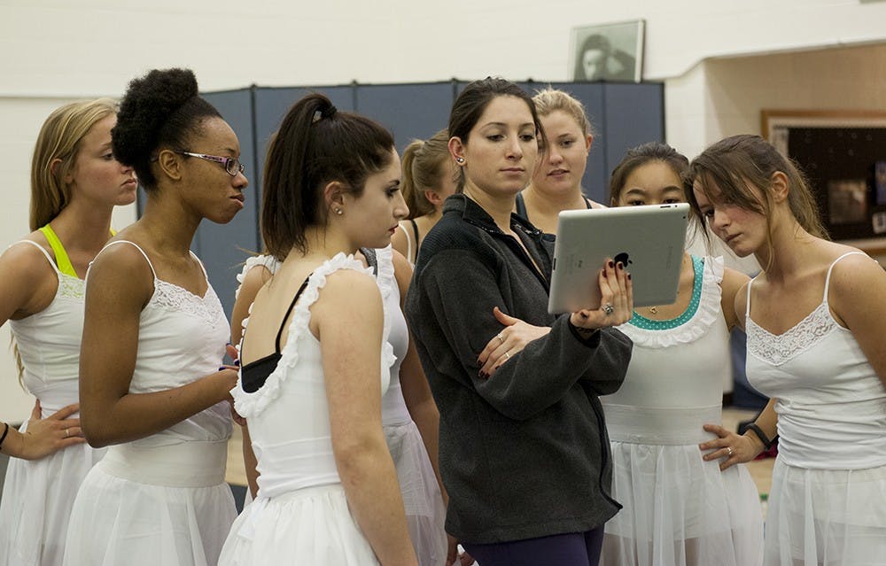 Alyssa Condotti, a Contemporary Dance Major goes through some pointers on her iPad with her dancers. Condotti is a senior and her dance segment 'Mind Matters' is part 'Exit Notes', a show done by senior dance students. 