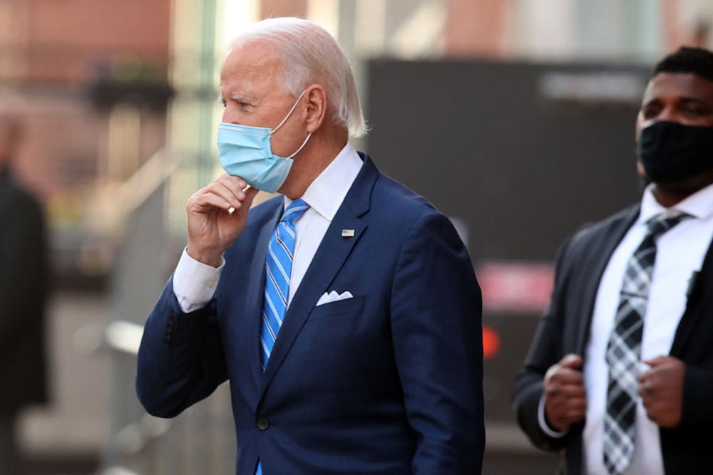President-elect Joe Biden adjusts his face mask as he leaves the Queen Theater on Dec. 7 in Wilmington, Delaware.