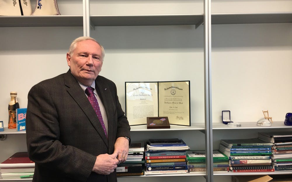 IU professor of practice Gene Coyle stands in his office with his 1986 CIA Medal of Merit. During the Cold War he recruited spies for the CIA.
