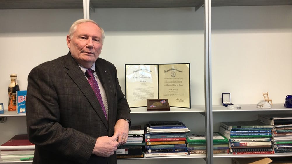 IU professor of practice Gene Coyle stands in his office with his 1986 CIA Medal of Merit. During the Cold War he recruited spies for the CIA.