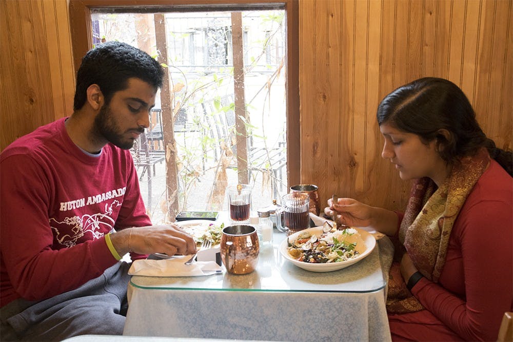 IU seniors, Parth Patel (left) and Roshni Dhoot participate in a dine and donate event at Anatolia Restaurant on Thursday evening. 