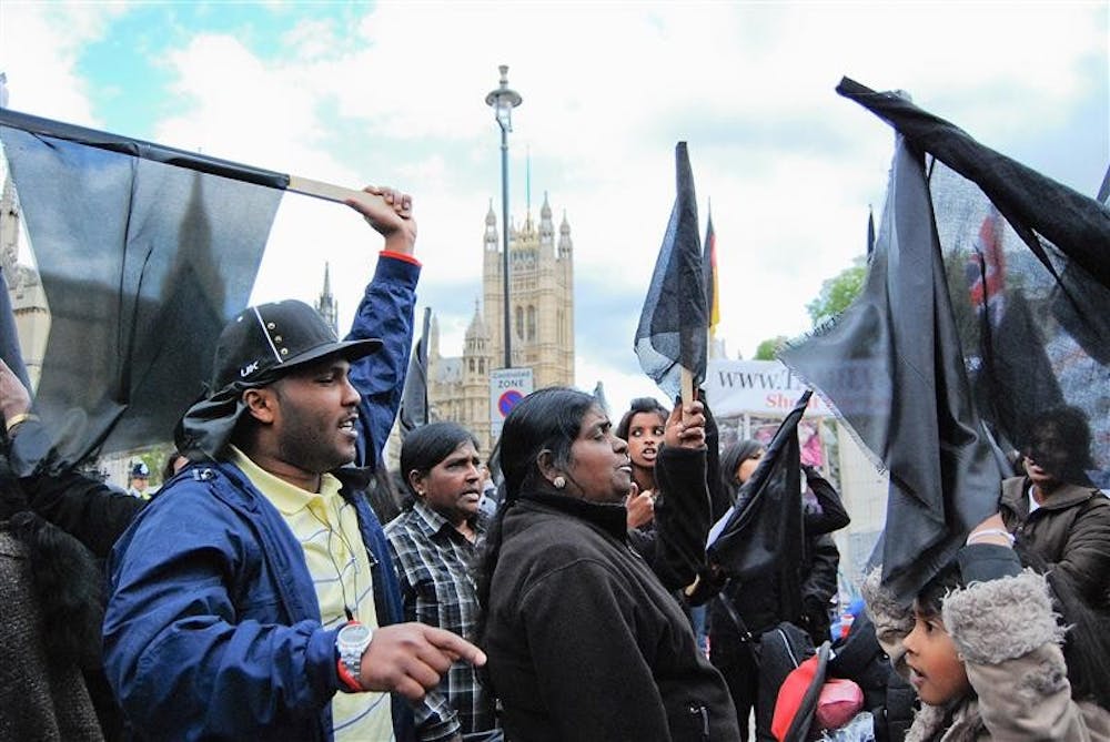 British Tamils gather to support Sri Lanka's Tamil community in Sri Lanka during a vigil Friday afternoon at the Houses of Parliament in London.