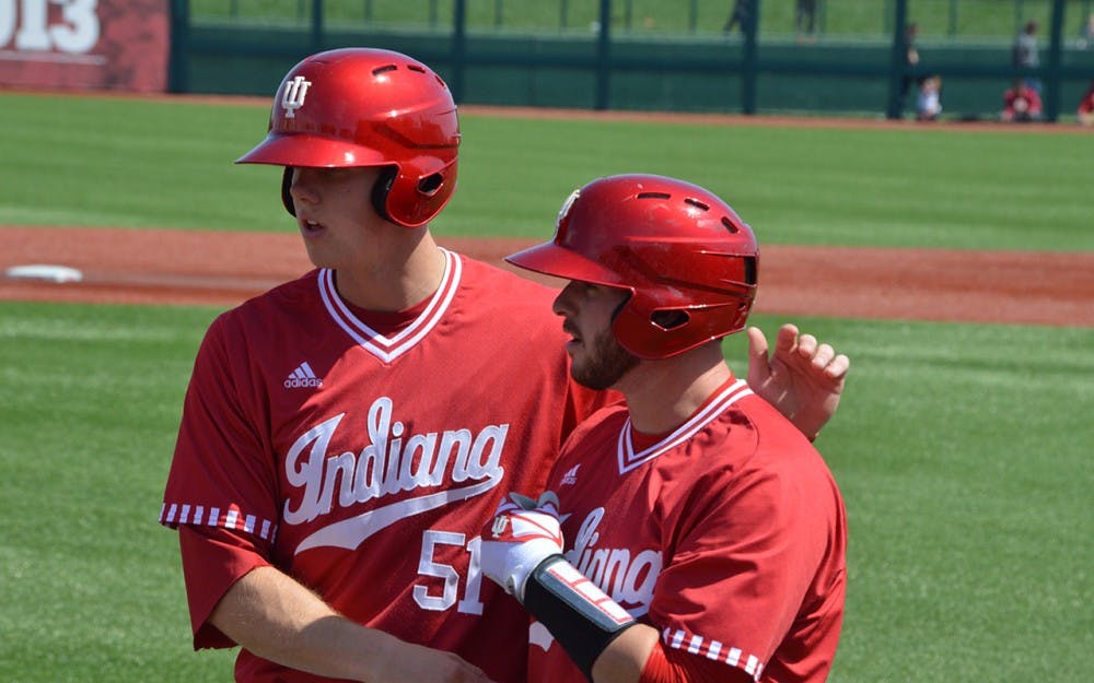 Senior Alex Krupa congratulates junior Logan Sowers on his first double of game three against Nebraska. Sowers hit an RBI double to get IU on the board against Indiana State in the Hoosiers' 2-0 win.