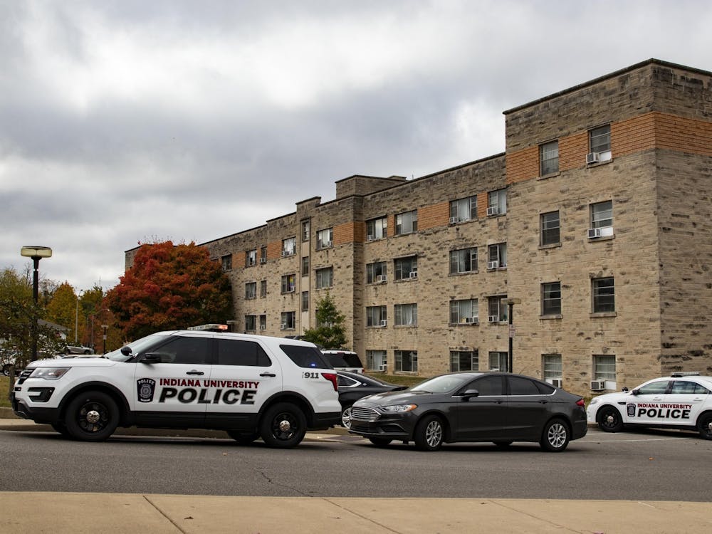 Indiana University Police Department cars are parked in front of University East apartments Oct. 12 on IU’s campus. The body of a male student was found Monday morning in IU’s University East apartments, IUPD Deputy Chief Shannon Bunger said.