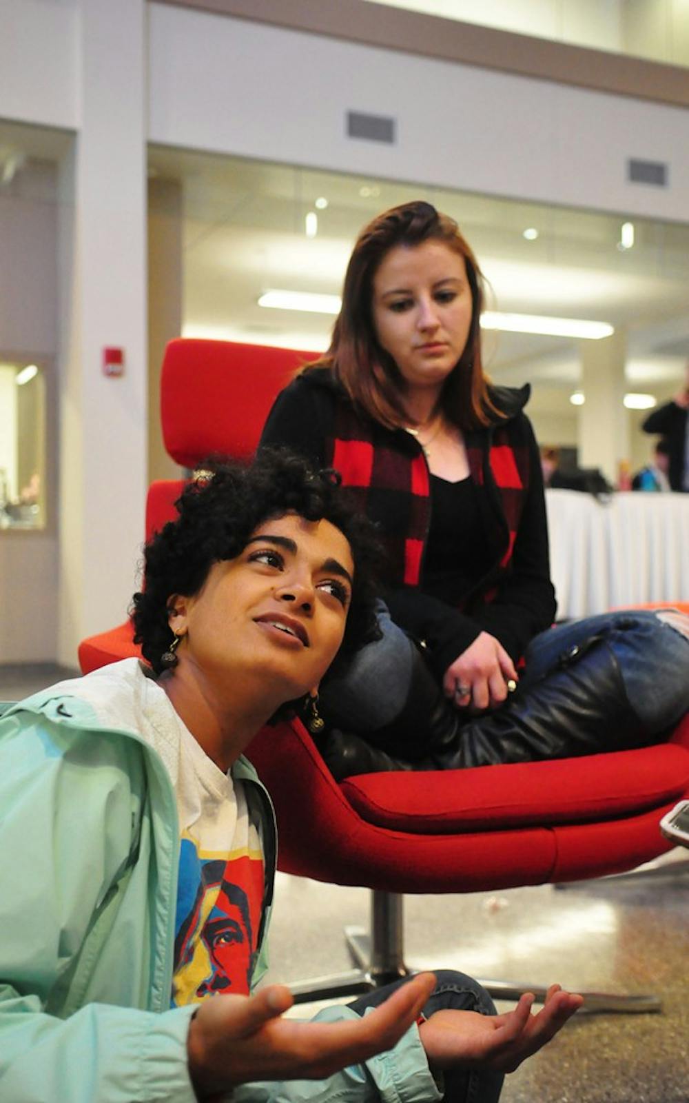 Students Sheila Ragavendran, left, and Amanda Marino watch and wait in the atrium of Franklin Hall as a close race leaves the winner of the 2016 Presidential election uncertain.