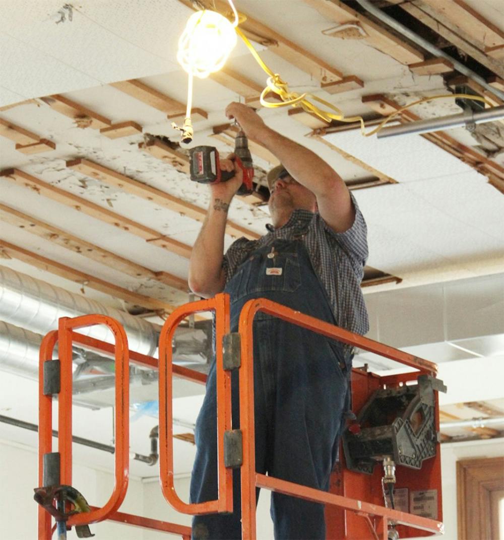 The construction worker drills up the nails to the ceiling Thursday inside of the Kirkwood Hall. Kirkwood Hall is planned to be finished the renovation this year.