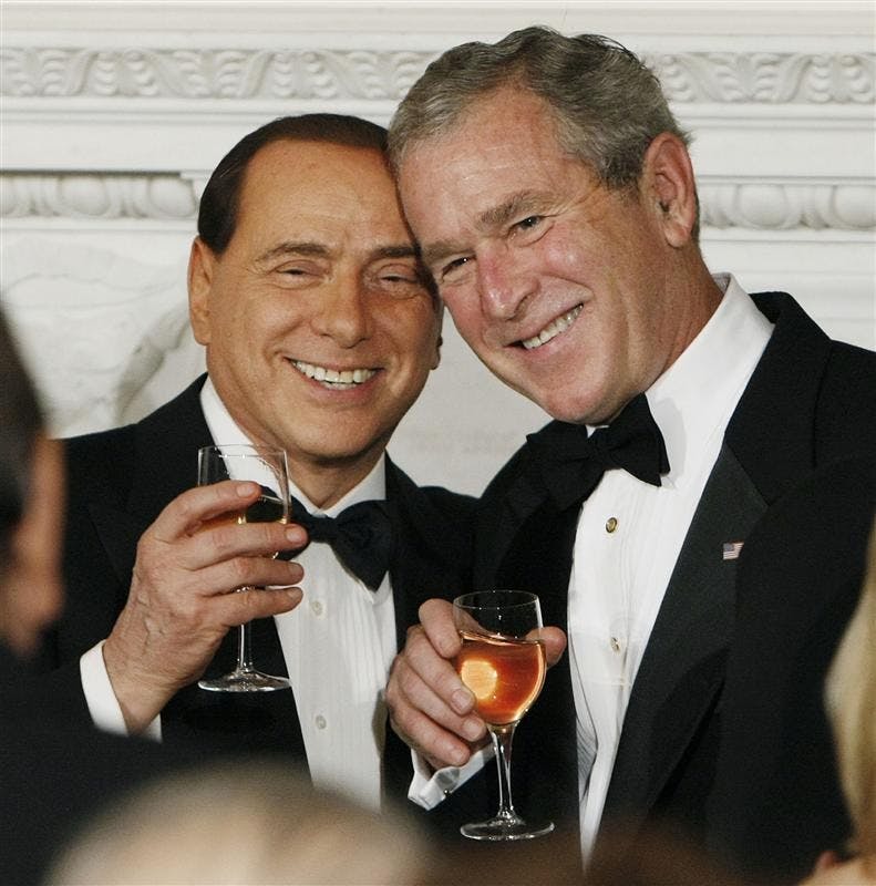 President Bush, right, toasts with the Prime Minister of Italy Silvio Berlusconi, left, during an Official Dinner in the State Dining Room on Monday in Washington. 