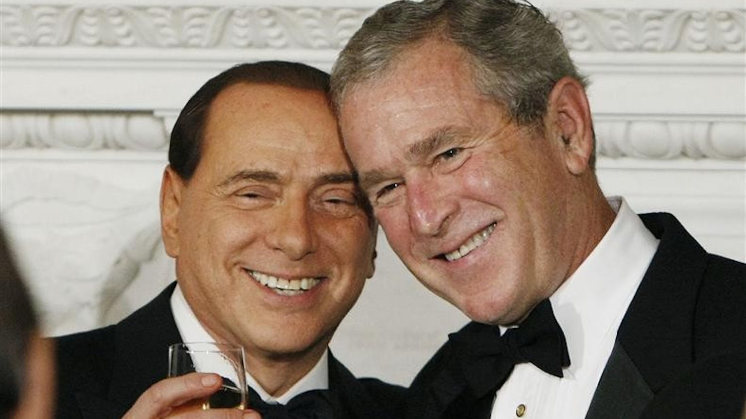 President Bush, right, toasts with the Prime Minister of Italy Silvio Berlusconi, left, during an Official Dinner in the State Dining Room on Monday in Washington. 