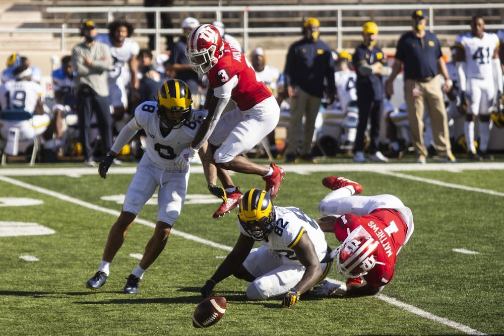 <p>Then-sophomore Tiawan Mullen jumps over the Michigan offense Nov. 7, 2020, at Memorial Stadium. Indiana scored 23 points in the third quarter.</p>
