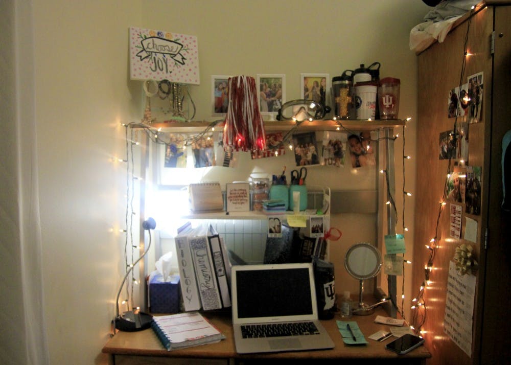 <p>Despite having a small work space, freshman Brooklynn Weisenbach makes the most of it and decorates with photos and Christmas lights. "I only study in my dorm," Weisenbach said. "It's easy for me to differentiate schoolwork and relaxing time even when working in my room."</p>