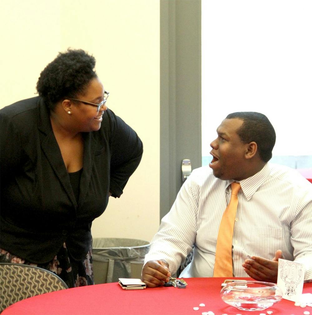 Monica Green, a new director of the Neal Marshall Cultural Center talks with her future husband, Michael Johnson  Wednesday at the Neal Marshall New Director Meet and Greet. 