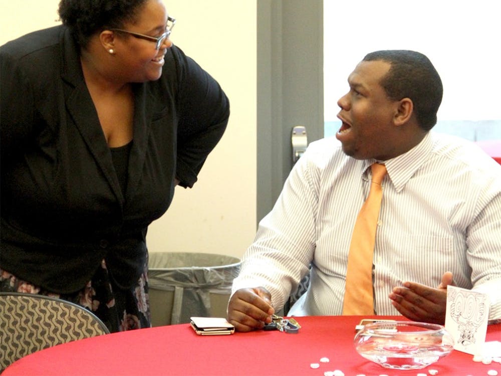 Monica Green, a new director of the Neal Marshall Cultural Center talks with her future husband, Michael Johnson  Wednesday at the Neal Marshall New Director Meet and Greet. 