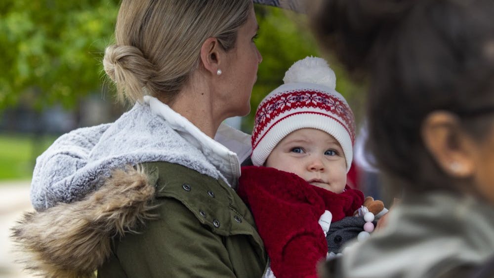 Eleven-month-old Emma Starr looks out at the 2019 IU Homecoming Parade on Oct. 11 on Woodlawn Avenue. In the United States it can cost nearly $19 thousand on average to have a baby.