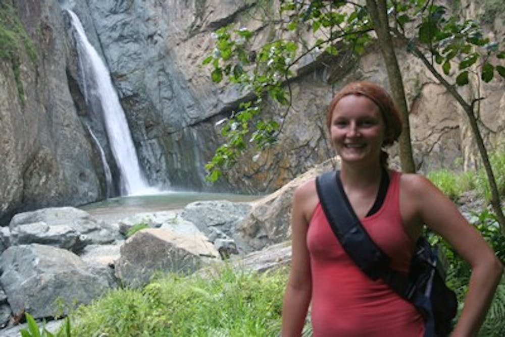 Chelsea Merta stands in front of the tallest cascade in the Carribean.