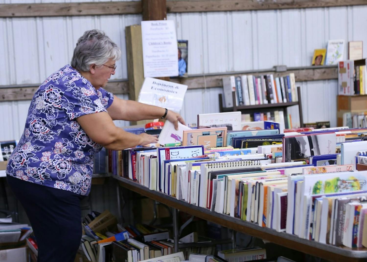 Rullen Fessenbecker searches for books at the Bloomington Community Book Fair, hosted by Hoosier Hills Food Bank. Fessenbecker, who lives in Nashville, Indiana, has visited the book fair more than 10 times.