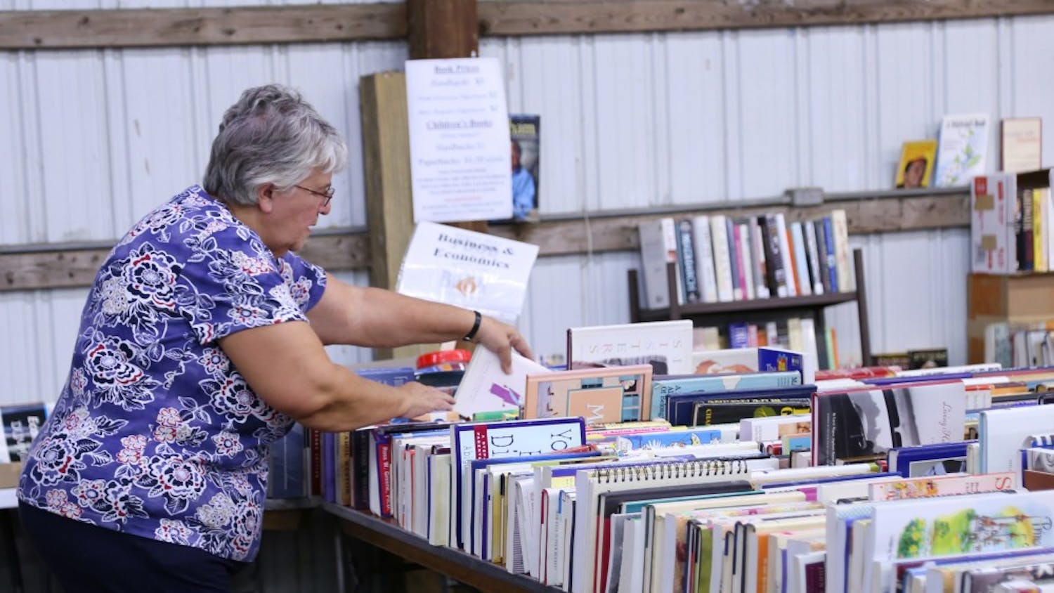 Rullen Fessenbecker searches for books at the Bloomington Community Book Fair, hosted by Hoosier Hills Food Bank. Fessenbecker, who lives in Nashville, Indiana, has visited the book fair more than 10 times.