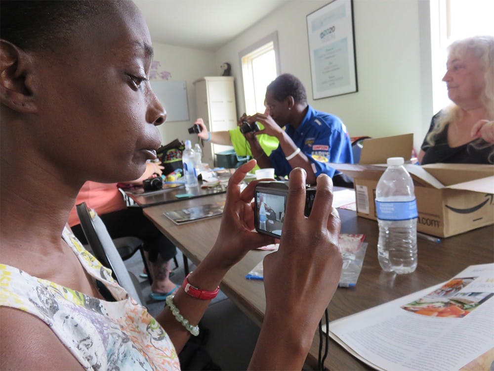 Amelia Dixon examines her new camera at the first instructional meeting at Shalom Community Center. 
