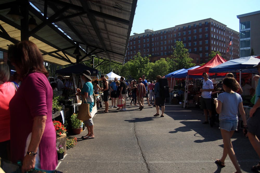 <p>People walk through the aisles of vendors at the Bloomington Community Farmers&#x27; Market near City Hall in 2018. Some community members responded angrily to a statement made by the Broadening Inclusion Group of the market Friday on Facebook.</p>