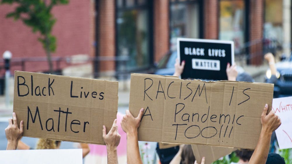 Protesters hold signs above their heads June 9, 2020, outside the Monroe County Courthouse. An Alabama high school organized a walkout on Feb. 8, 2023, after students were told they could not reference events before the 1970s in their Black History Month presentation.