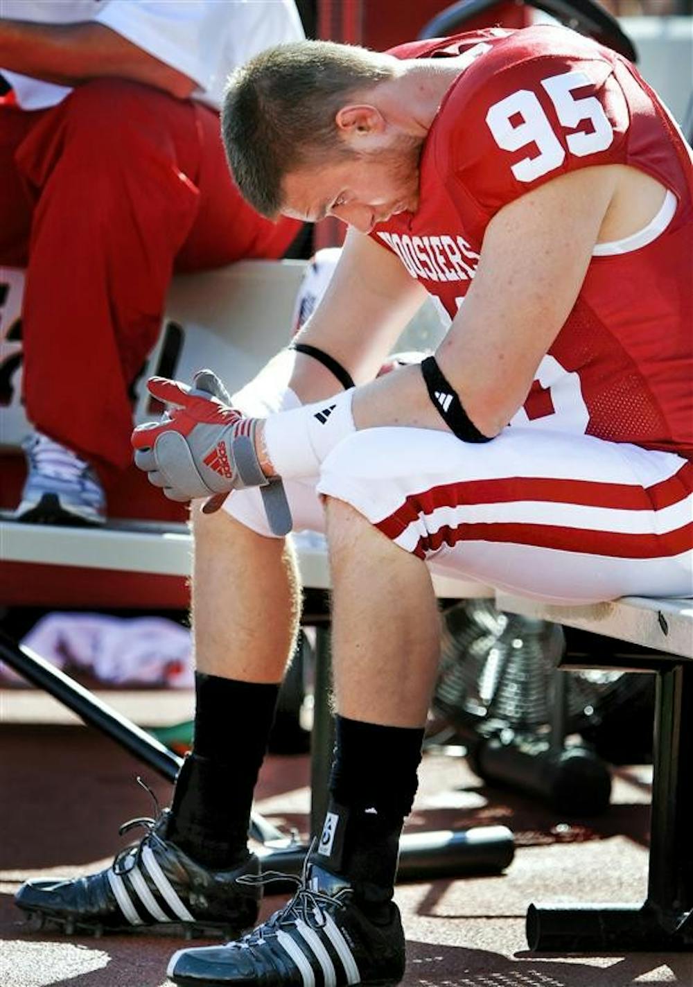 IU senior defensive lineman Arik Wolf takes a moment on the sideline near the end of the Hoosiers 45-9 loss to Iowa on Saturday afternoon at Memorial Stadium.