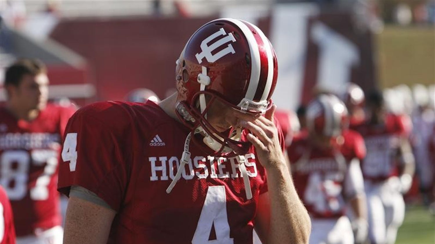 IU quarterback Ben Chappell covers his face as he walks off the field after Saturday's loss to Central Michigan at Memorial Stadium.