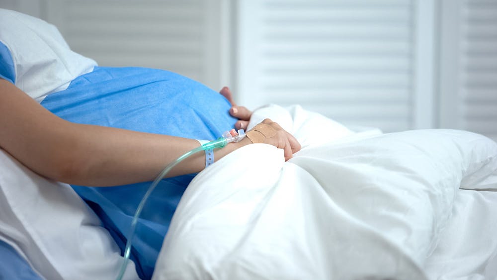 <p>A pregnant woman lays in a hospital bed. The FDA approved Zurzuvae, the first pill to treat postpartum depression, Aug. 4, 2023.</p>