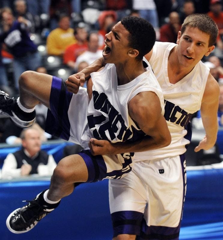 Bloomington South's Jacob Mulinix, right, grabs teammate Darwin Davis Jr. after they defeated Fort Wayne Snider 69-62 in the IHSAA Class 4A boys basketball state finals at Conseco FieldhouseSaturday in Indianapolis. (AP Photo/Tom Strickland)
