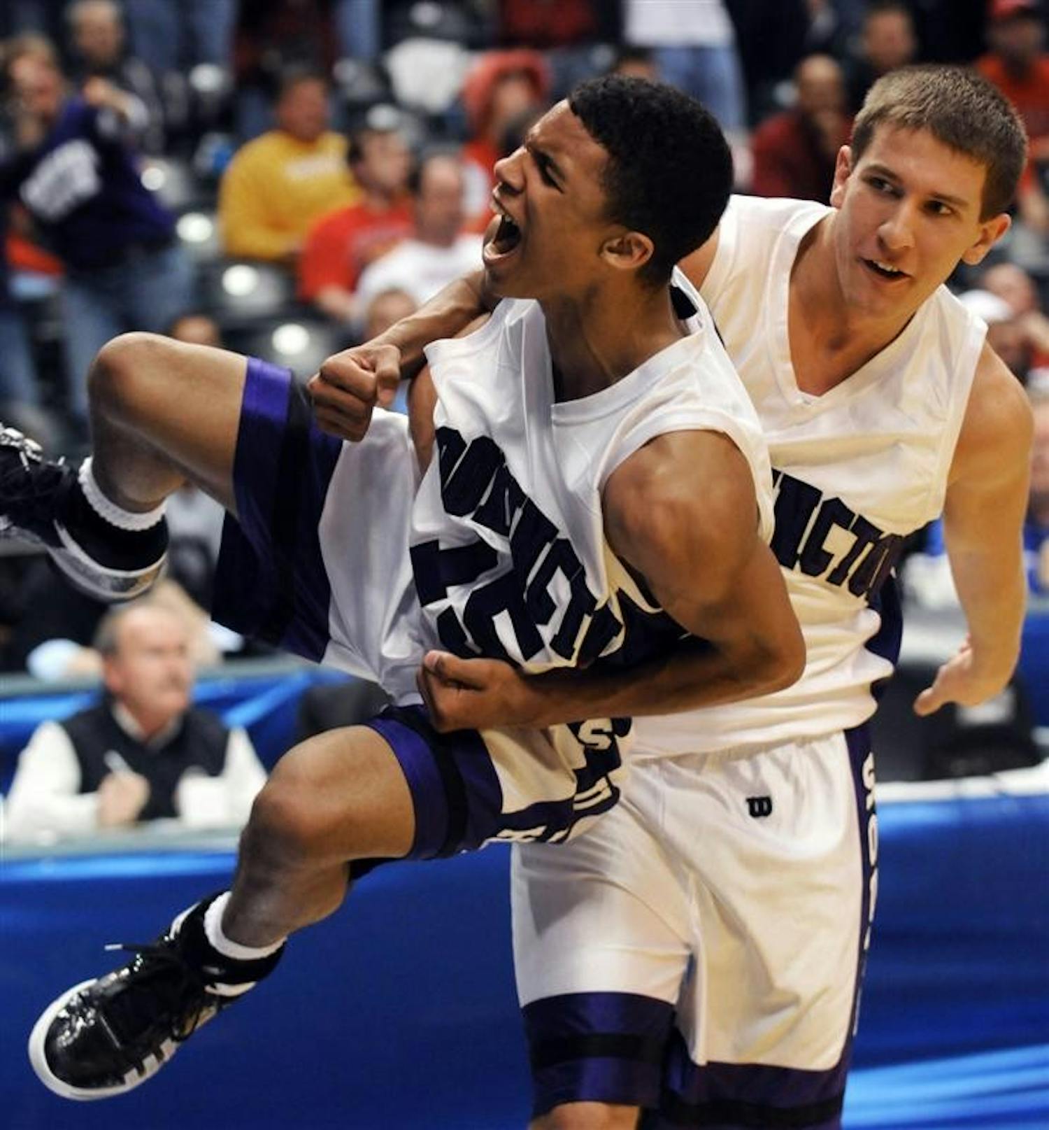 Bloomington South's Jacob Mulinix, right, grabs teammate Darwin Davis Jr. after they defeated Fort Wayne Snider 69-62 in the IHSAA Class 4A boys basketball state finals at Conseco FieldhouseSaturday in Indianapolis. (AP Photo/Tom Strickland)