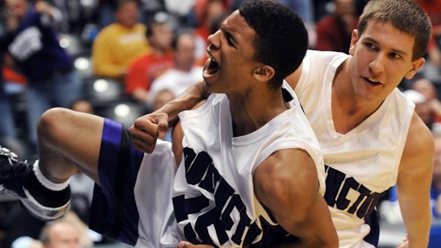 Bloomington South's Jacob Mulinix, right, grabs teammate Darwin Davis Jr. after they defeated Fort Wayne Snider 69-62 in the IHSAA Class 4A boys basketball state finals at Conseco FieldhouseSaturday in Indianapolis. (AP Photo/Tom Strickland)